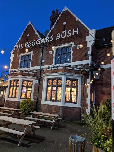 The Beggars Bush at dusk, with the pub’s name painted on the gable