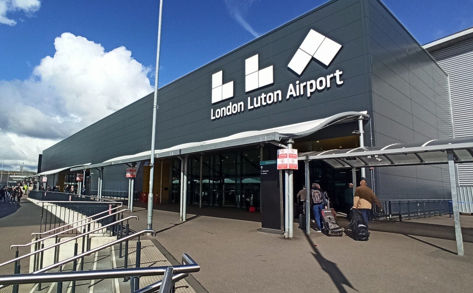 The terminal entrance at London Luton Airport, with the airport name in large letters above the doors
