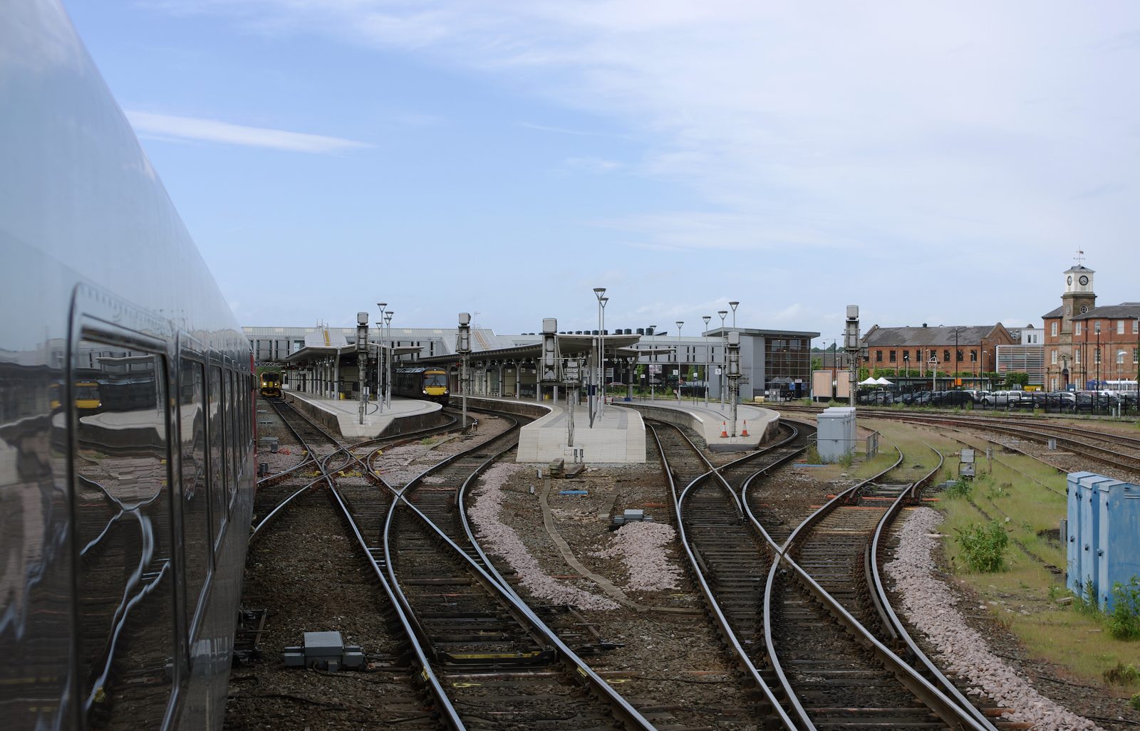 Trains at Derby railway station seen across converging tracks