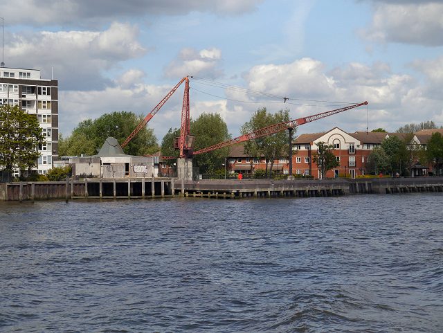 The River Thames at Rotherhithe in London, with a preserved dockside crane and riverside housing