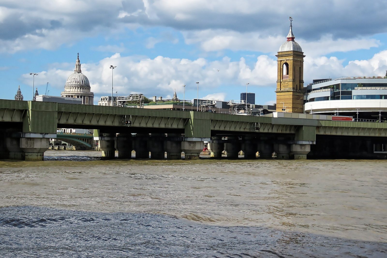 Cannon Street Railway Bridge over the River Thames in London, with the dome of St Paul's Cathedral behind