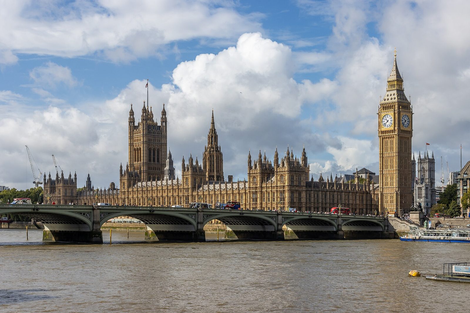 Westminster Bridge and the Palace of Westminster in London under a cloudy sky