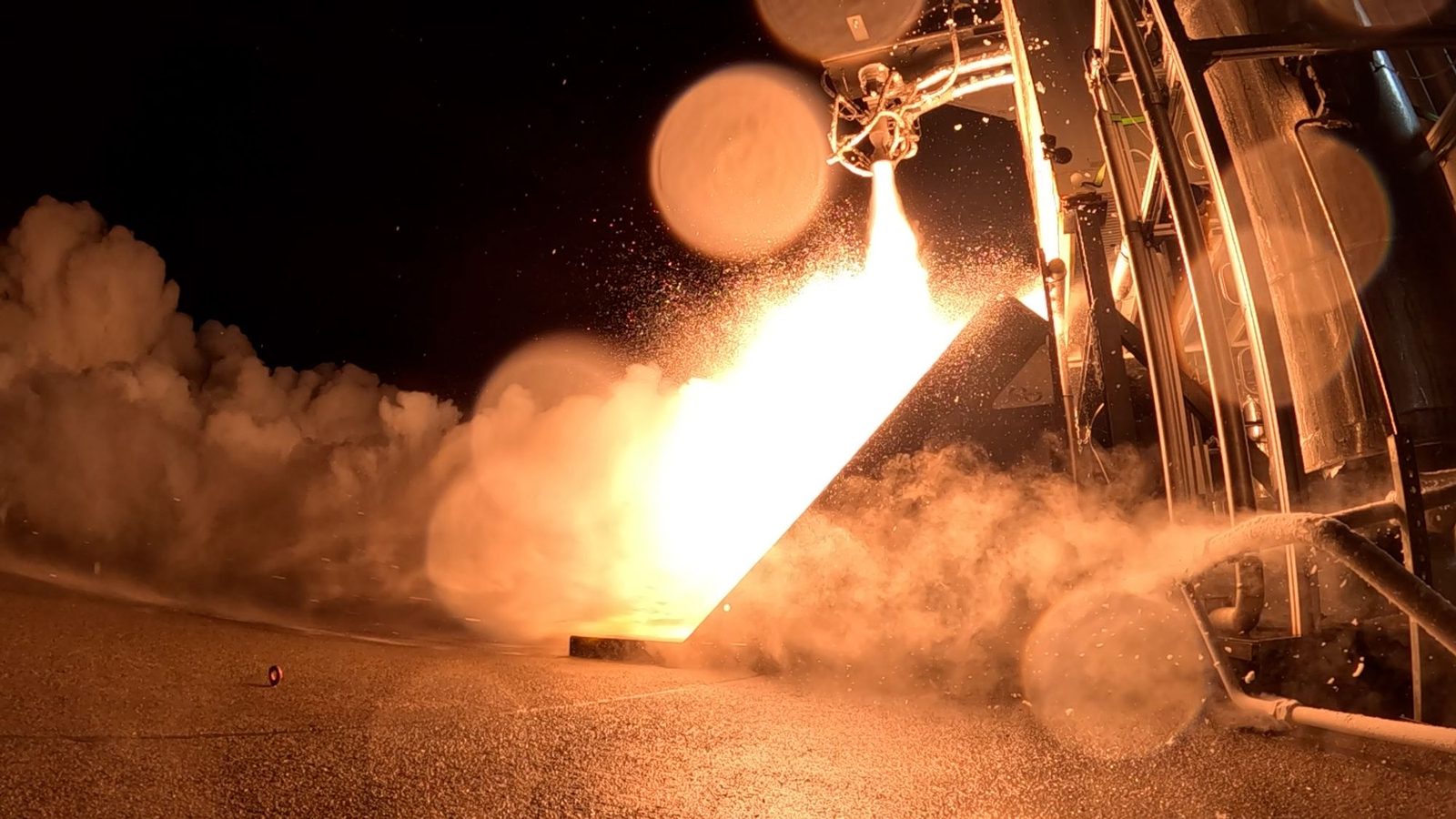 A rocket engine firing test at night at SaxaVord Spaceport in Shetland