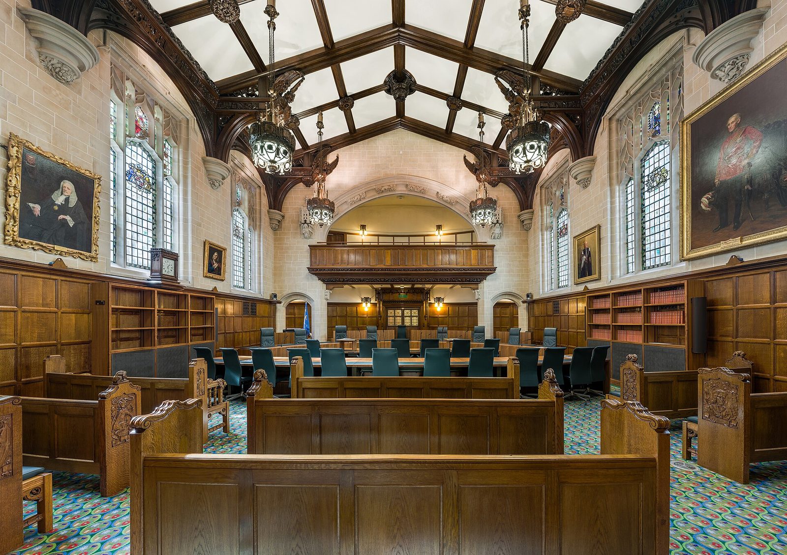 The wood-panelled interior of Court 1 at the Supreme Court in London, with rows of seats and a high vaulted ceiling