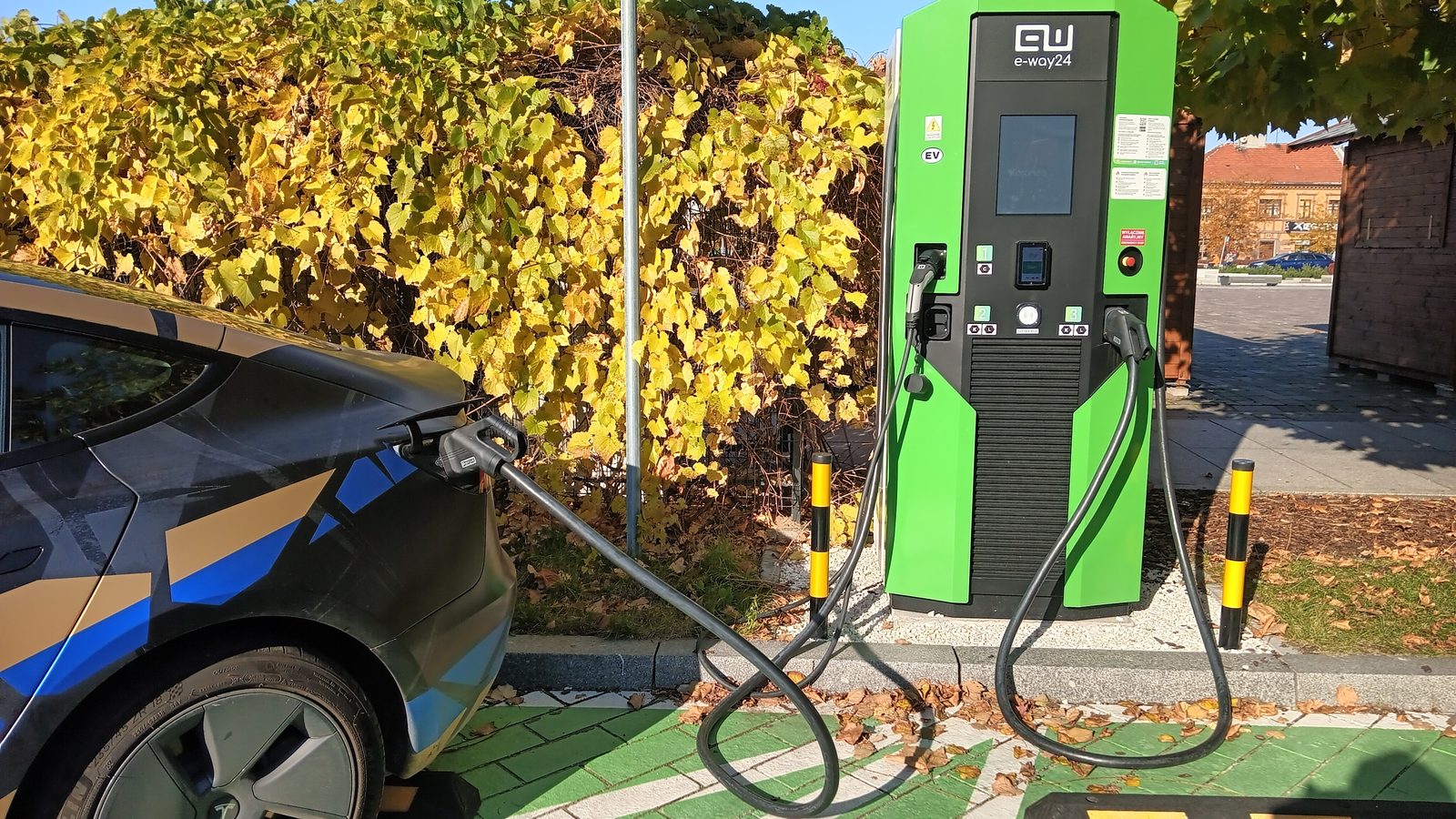 A Tesla Model 3 charging at a public charging point