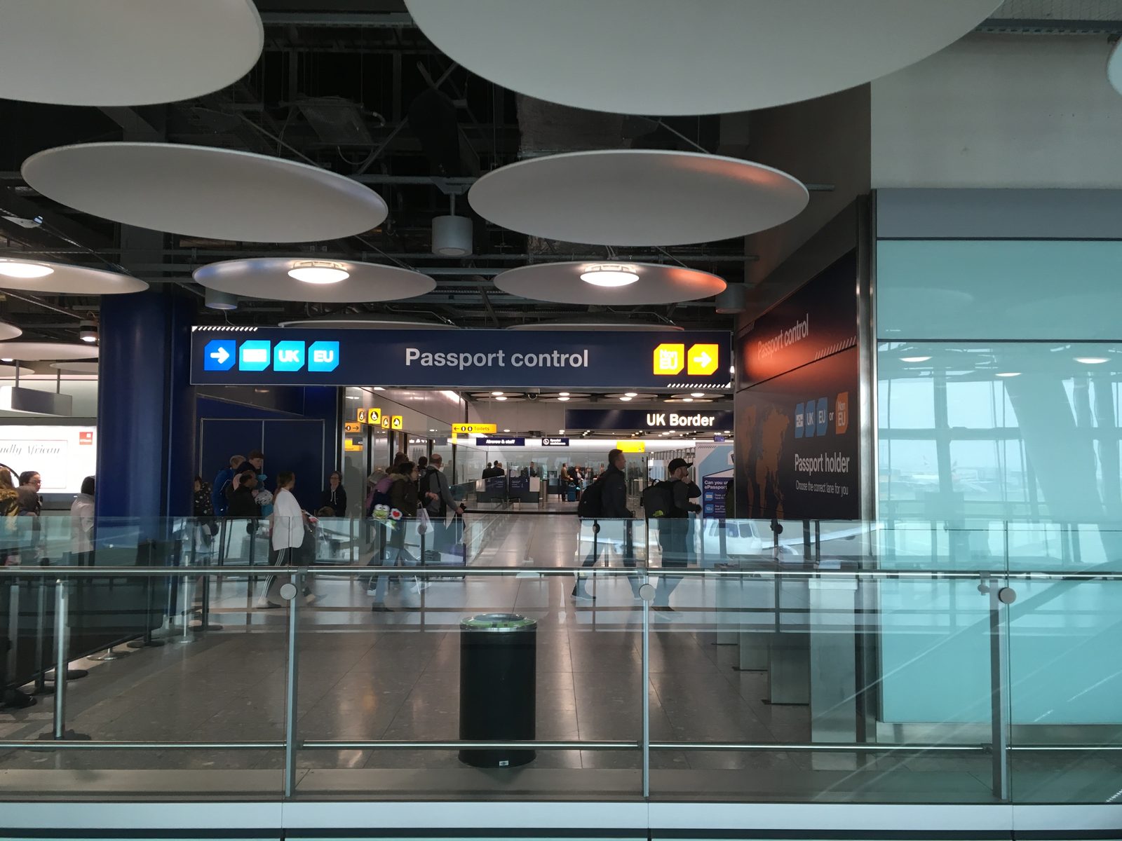 Passport control and UK Border signs at a British airport